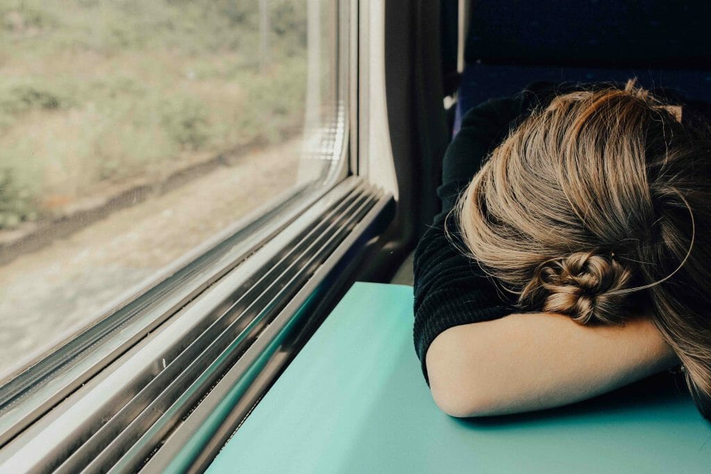 How Hemp Oil Can Improve Your Sleep 2 woman sleeping tired on train sleeplessness