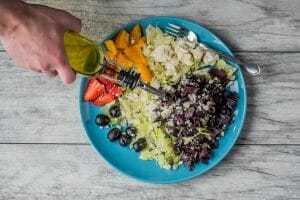 5 New and Innovative Ways to Take CBD 7 person pouring oil dressing over salad